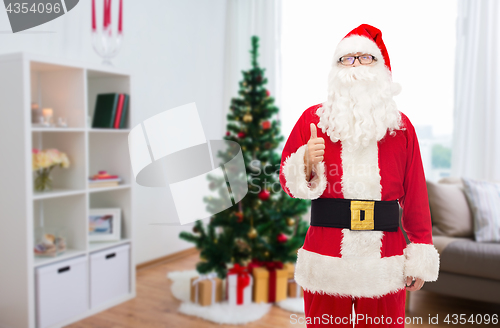 Image of santa claus showing thumbs up at christmas home