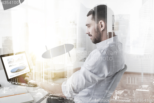 Image of businessman with charts on laptop screen at office