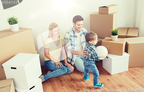 Image of happy family moving to new home and playing ball