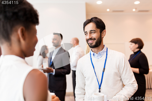 Image of business people with conference badges and coffee