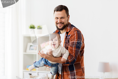 Image of happy father with little baby boy at home