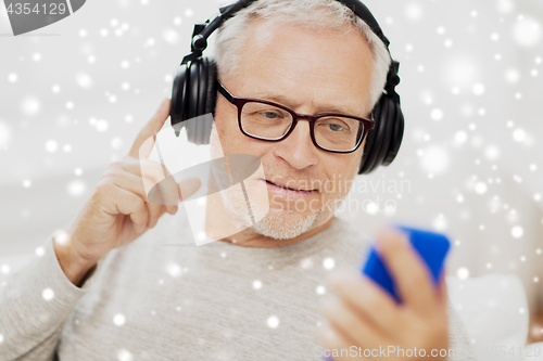 Image of happy senior man with smartphone and headphones