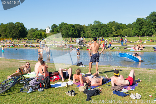 Image of People enjoying the summer day in Englischer Garten city park in Munich, Germany.