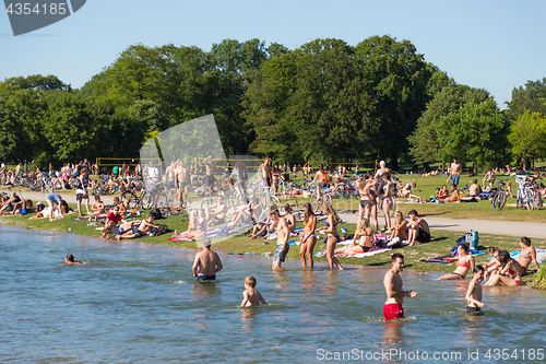 Image of People enjoying the summer day in Englischer Garten city park in Munich, Germany.