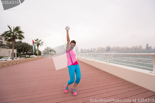 Image of young woman celebrating a successful training run