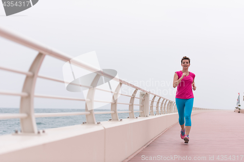 Image of woman busy running on the promenade