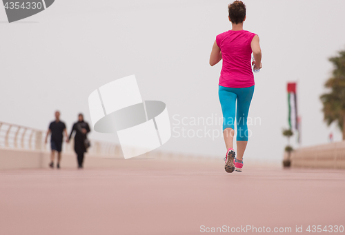 Image of woman busy running on the promenade