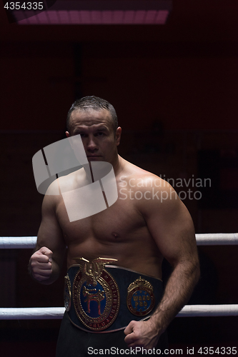 Image of kick boxer with his championship belt