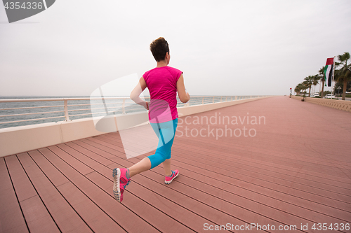 Image of woman busy running on the promenade