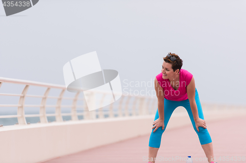 Image of woman stretching and warming up on the promenade