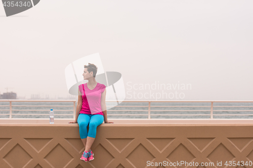 Image of young woman sitting after a successful training run