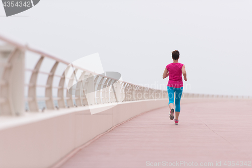 Image of woman busy running on the promenade