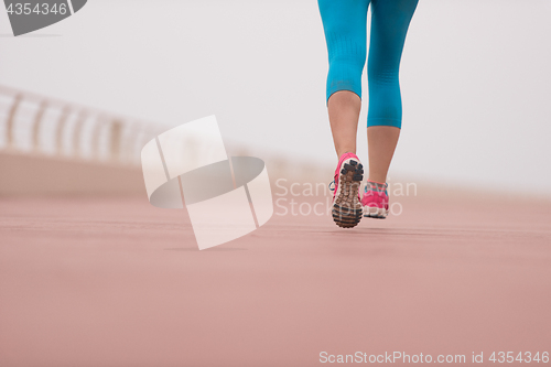 Image of woman busy running on the promenade