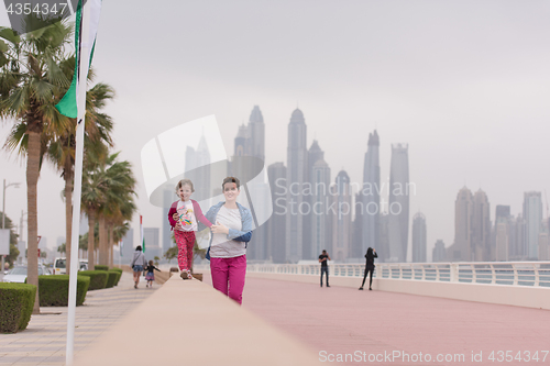 Image of mother and cute little girl on the promenade