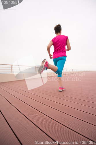 Image of woman busy running on the promenade