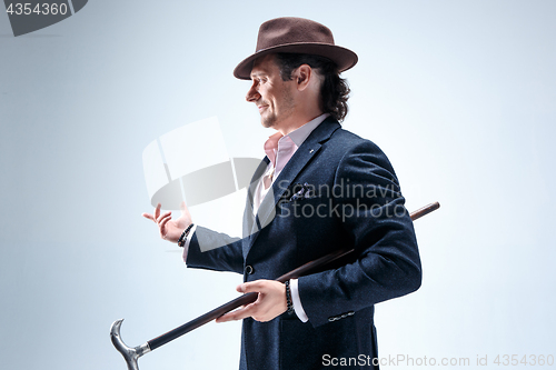 Image of Young man portrait with hat on gray studio background.