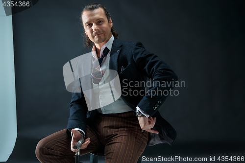 Image of Businessman sitting on an armchair