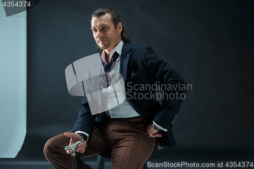 Image of Businessman sitting on an armchair