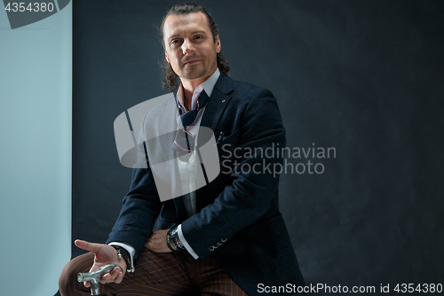 Image of Businessman sitting on an armchair