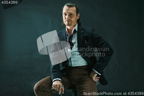 Image of Businessman sitting on an armchair