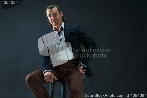 Image of Businessman sitting on an armchair