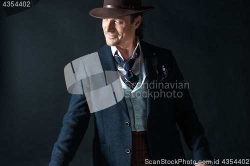 Image of Young man portrait with hat on gray studio background.