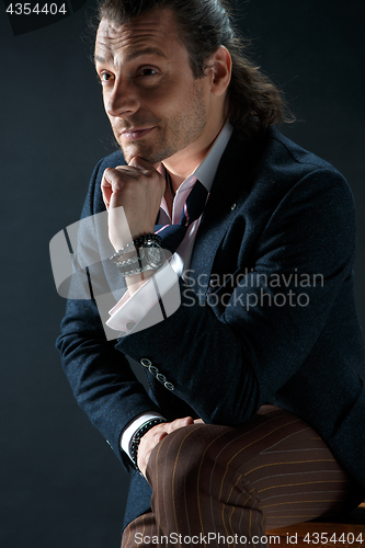 Image of Businessman sitting on an armchair