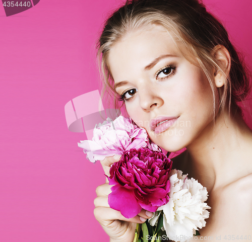 Image of young beauty woman with flower peony pink closeup makeup soft te