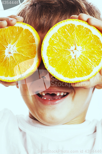 Image of little cute boy with orange fruit double isolated on white smili