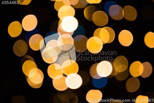 Image of blurred golden lights over dark background