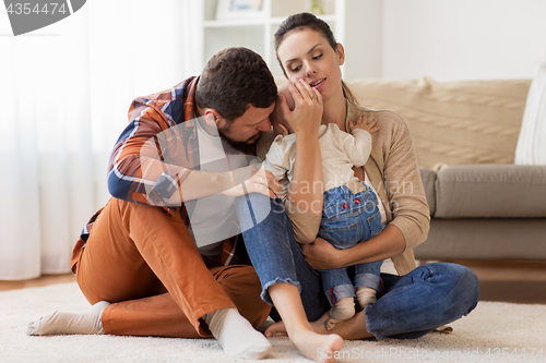 Image of happy family with baby at home