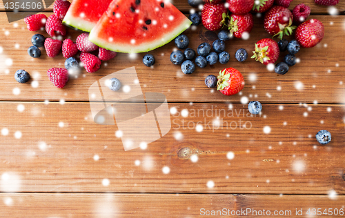 Image of close up of fruits and berries on wooden table