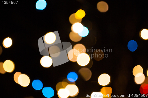 Image of blurred golden lights over dark background