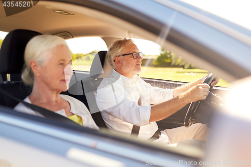 Image of happy senior couple driving in car