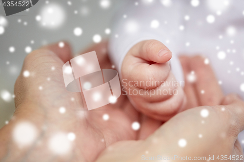 Image of close up of mother and newborn baby hands