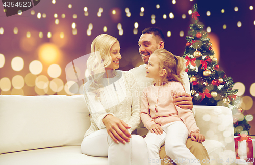 Image of happy family at home with christmas tree
