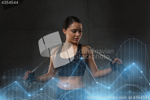 Image of young sporty woman with jumping rope