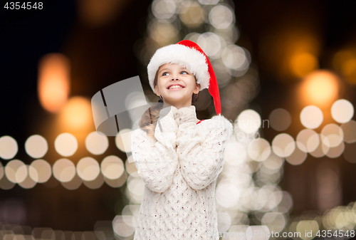 Image of dreaming girl in santa helper hat