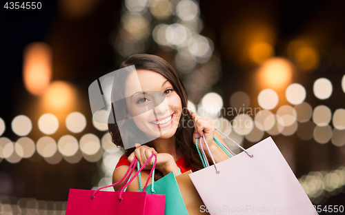Image of smiling woman with colorful shopping bags
