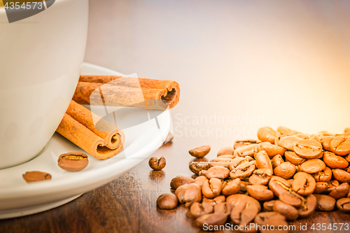 Image of Macro shot with white cup of coffee and cinnamon