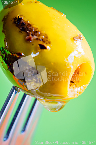 Image of Closeup grilled olive on the fork
