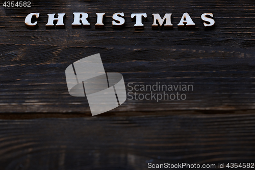 Image of Christmas text on a wooden wall