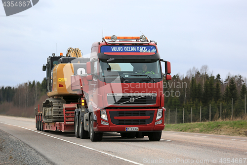 Image of Red Volvo FH Transports Heavy Machinery