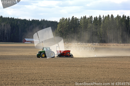 Image of John Deere Tractor and Seeder on Spring Field