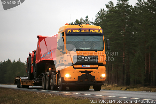 Image of Yellow MAN Truck Hauls Sandvik Machinery