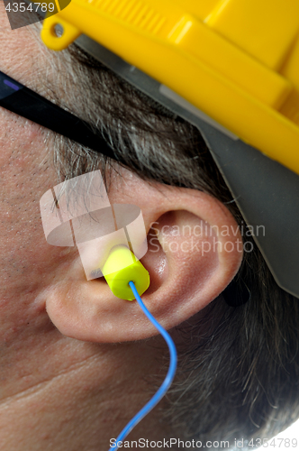 Image of man with protective ear plugs