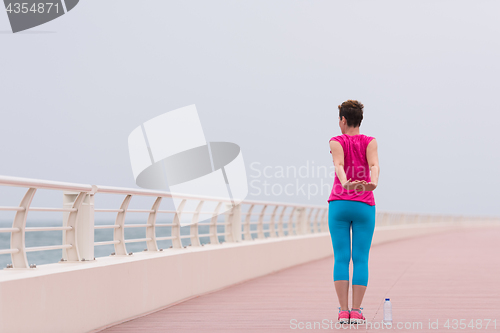 Image of woman stretching and warming up on the promenade