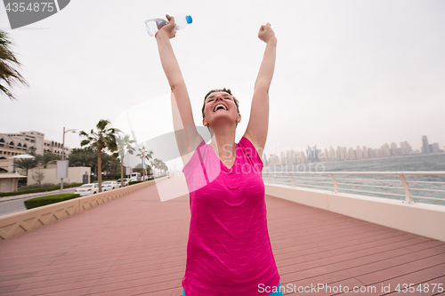 Image of young woman celebrating a successful training run