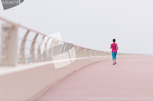 Image of woman busy running on the promenade