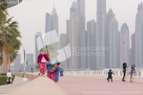 Image of mother and cute little girl on the promenade